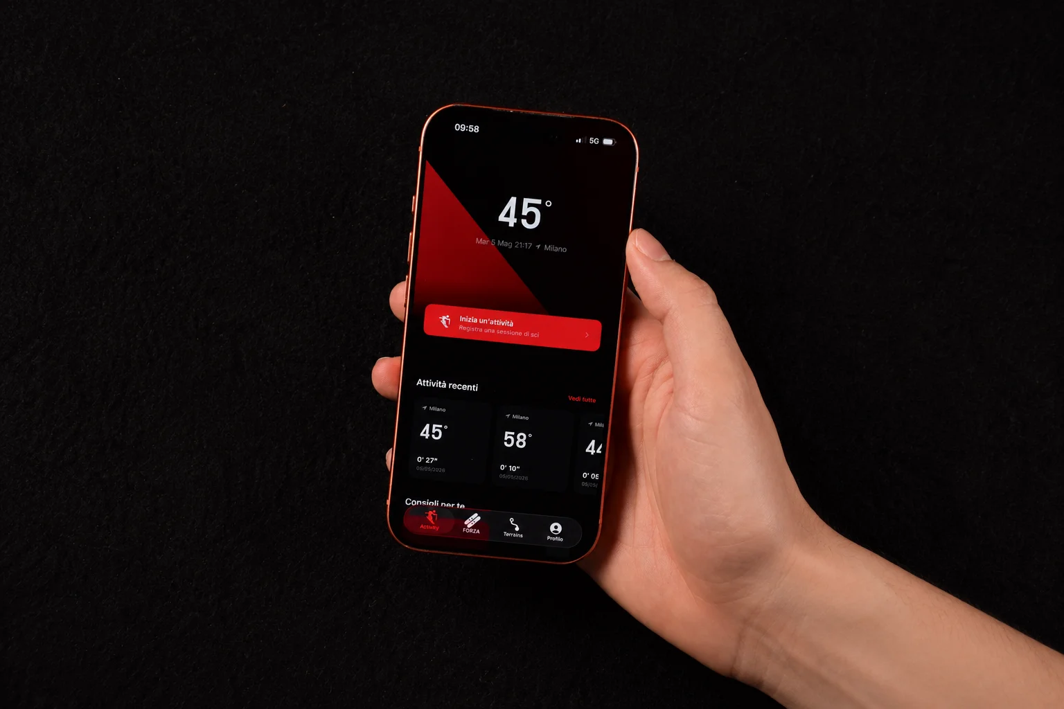 A hand holding an iPhone displaying the Rossignol Forza+ app